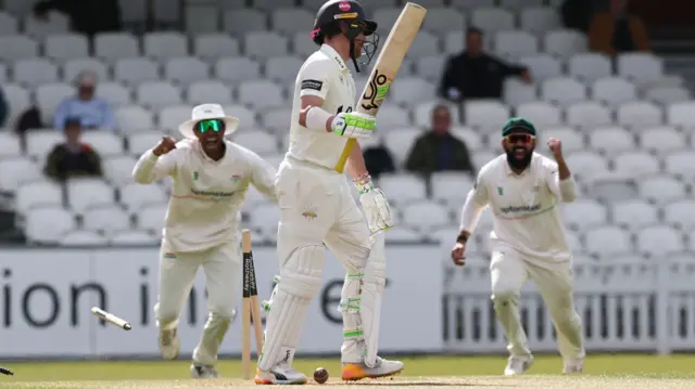 Leics celebrate as Surrey's Rory Burns walks off after getting out