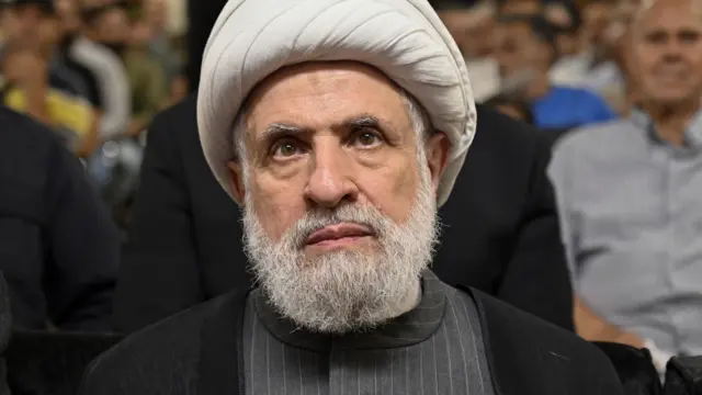 Sheikh Naim Qassem listens to a speech of then-Hezbollah leader Hassan Nasrallah (not pictured) via a screen at a memorial ceremony for senior Hezbollah commander, in a suburb outside Beirut, Lebanon, 19 June 2024