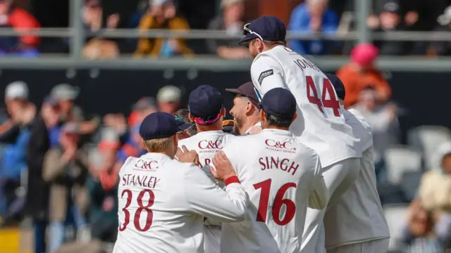 Lancashire players celebrate after beating Derbyshire
