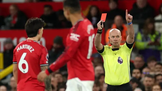 Paul Tierney shows Martinez a red card