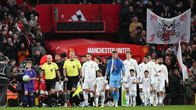 Leeds and Manchester players walk onto the pitch