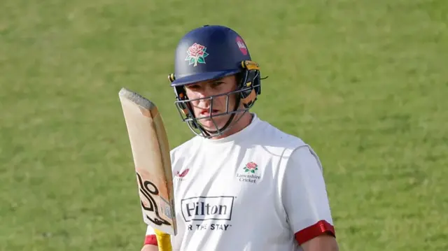 Marcus Harris holding up his bat to mark 50