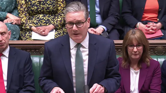 PM Keir Starmer, speaking at the despatch box in the House of Commons, surrounded by MPs