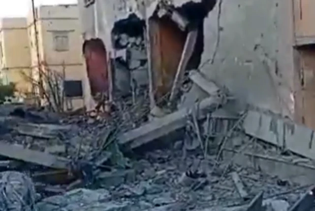 A freeze-frame from the verified video showing severe damage to a building in southern Lebanon