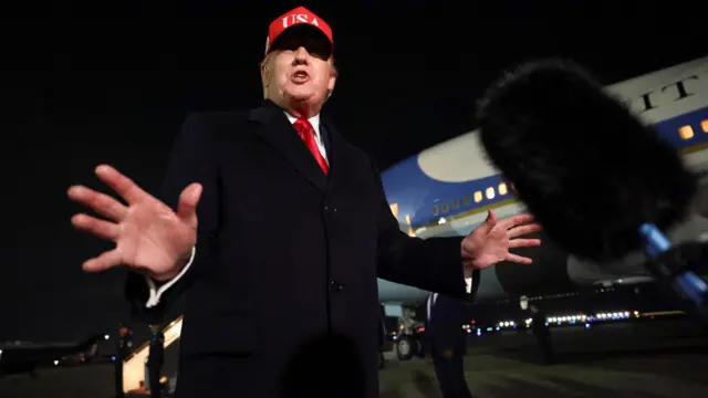 US President Donald Trump speaks to the members of the media after disembarking Air Force One as he arrives at Joint Base Andrews in Maryland, US on Sunday