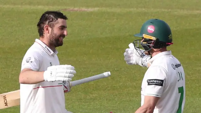 Stephen Eskinazi (with helmet off) prepares to hug helmeted Ben Cox