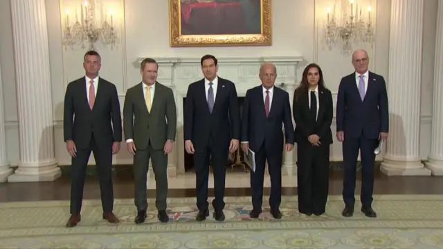 Six people stand in a line