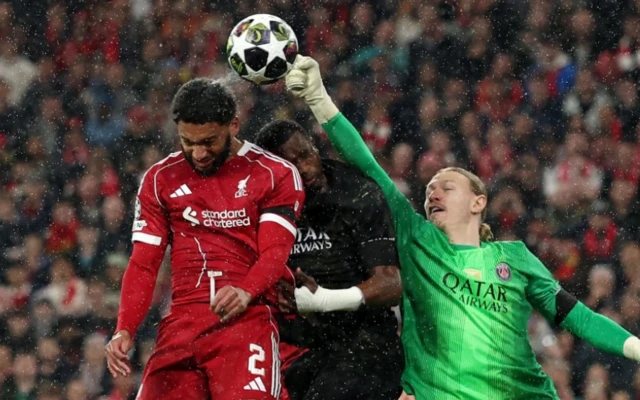 Paris St Germain's Matvey Safonov and Willian Pacho in action with Liverpool's Joe Gomez