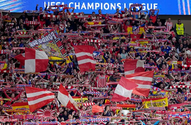 Fans of Atletico de Madrid hold up scarves