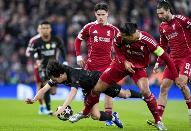Virgil van Dijk challenges for the ball