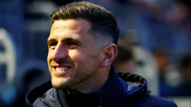 Portsmouth boss John Mousinho smiles