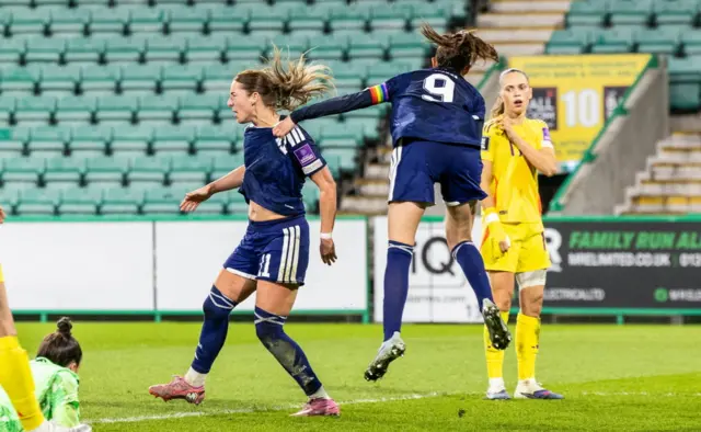 Scotland's Kathleen McGovern (L) celebrates with Caroline Weir (R) after scoring to make it 1-1 d