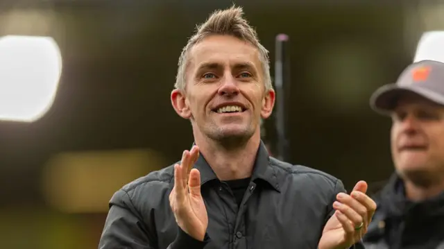 A smiling Kieran McKenna applauding Ipswich fans after their win at Norwich