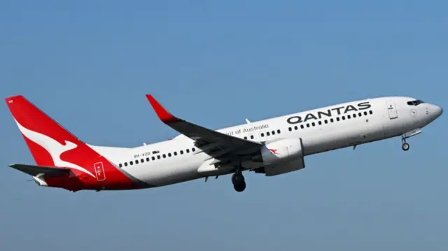 A Qantas plane pictured in mid-air during take-off