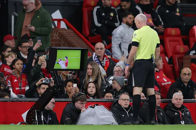 Referee Paul Tierney performs a VAR check