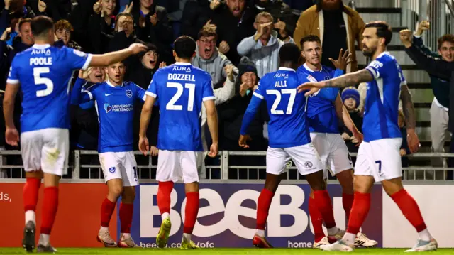 Portsmouth players celebrate in front of their fans