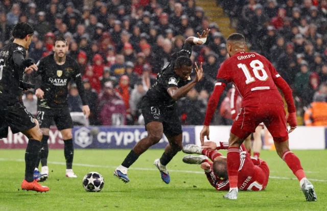 Paris St Germain's Willian Pacho concedes a penalty against Liverpool's Alexis Mac Allister