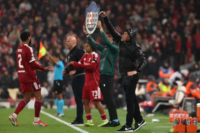 Paris Saint-Germain's Spanish head coach Luis Enrique (R) gestures as Liverpool's English striker #73 Rio Ngumoha (C) comes on