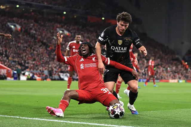 Jeremie Frimpong of Liverpool is challenged by Joao Neves
