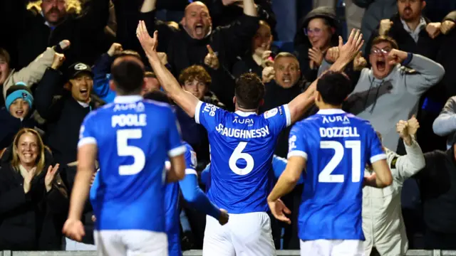 Conor Shaughnessy celebrates in front of the Pompey fans
