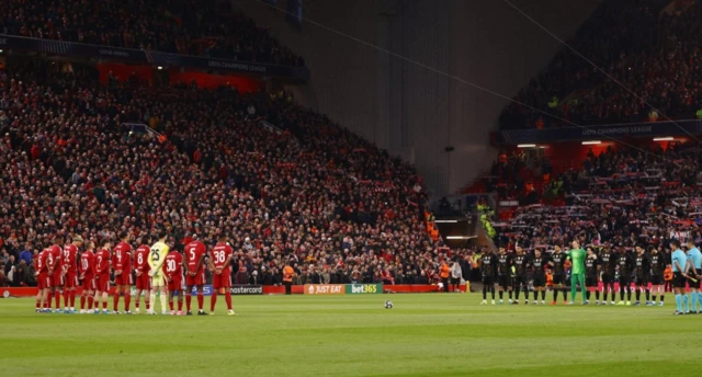 The teams line up during during a minutes silence