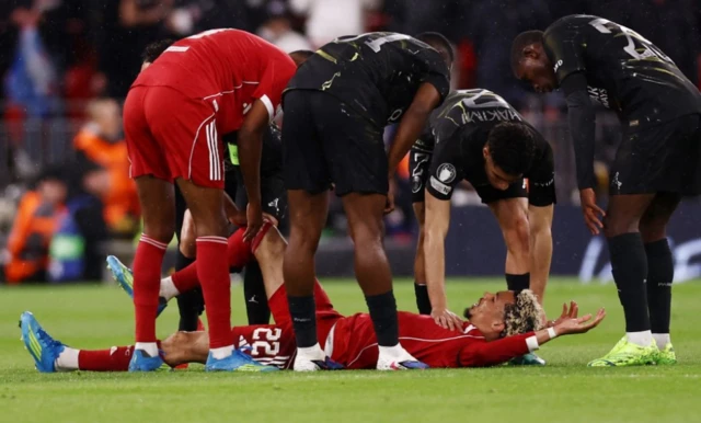 Liverpool's Hugo Ekitike reacts after sustaining an injury