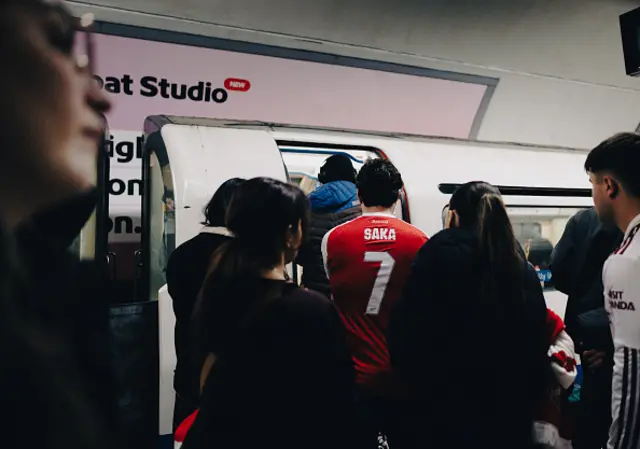 Fan wears Saka shirt on the tube