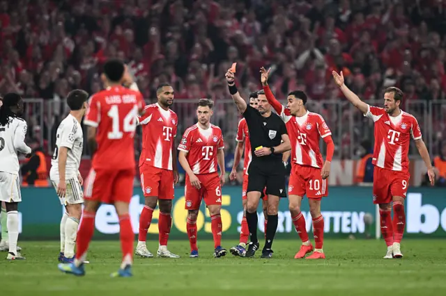 Referee Slavko Vincic shows a red card to Eduardo Camavinga