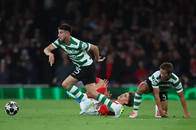 Gonçalo Inacio of Sporting Clube de Portugal, Hidemasa Morita of Sporting Clube de Portugal and Max Dowman of Arsenal challenge
