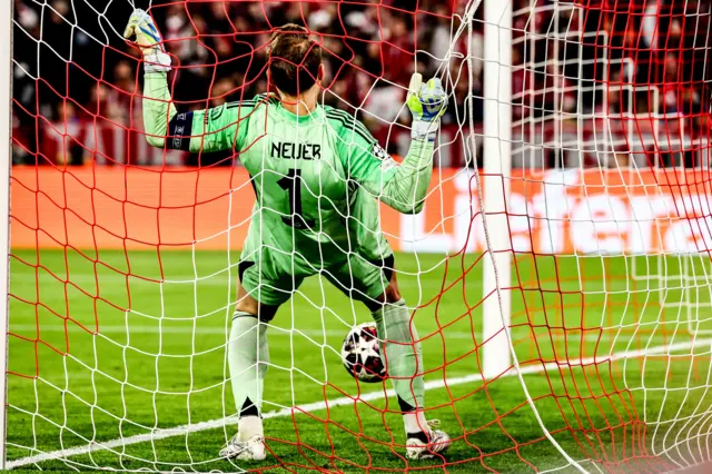 Goalkeeper Manuel Neuer of Bayern Munich holds onto the goal net