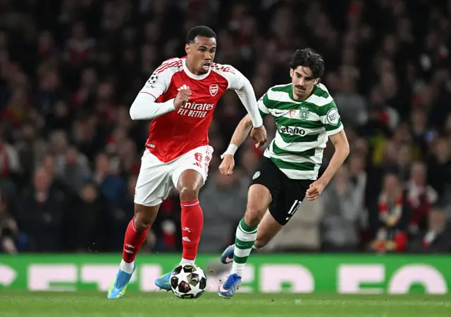 Gabriel of Arsenal runs with the ball whilst under pressure from Trincao of Sporting