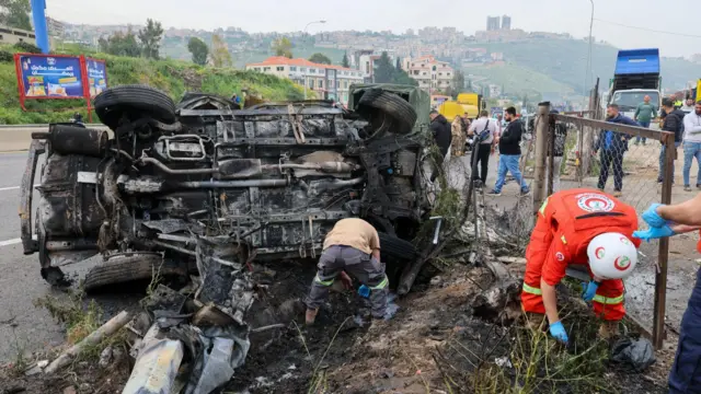 Rescuers work at the site of an Israeli airstrike that targeted a vehicle in Jiyeh town, south of Beirut, Lebanon, 15 April 2026.
