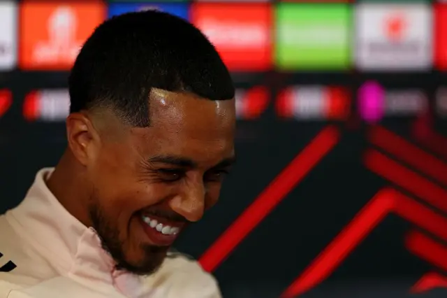 Youri Tielemans laughs as he talks to the media