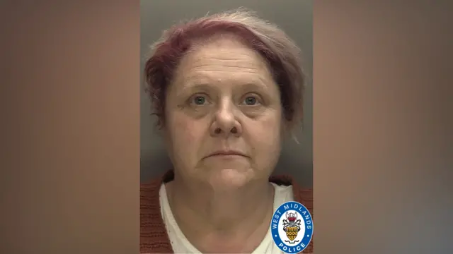 A mugshot of Deborah Lakewood. She has short pink hair