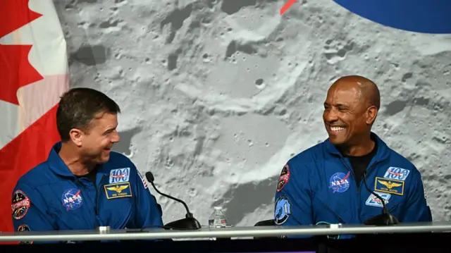 NASA's Artemis II mission commander Reid Wiseman (L) and pilot Victor Glover speak during a press conference