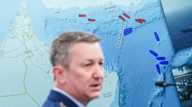 Chairman of the Joint Chiefs of Staff General Dan Caine speaks during a briefing on the Iran war, with a map in the background showing a blockade line on the Strait of Hormuz, at the Pentagon in Washington, D.C., U.S., April 16, 2026