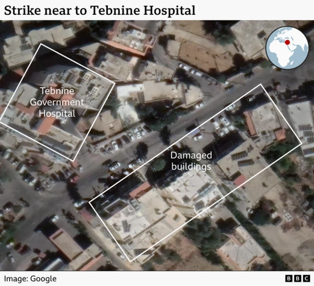 A satellite image showing the location of the hospital across the road from four buildings before they were damaged