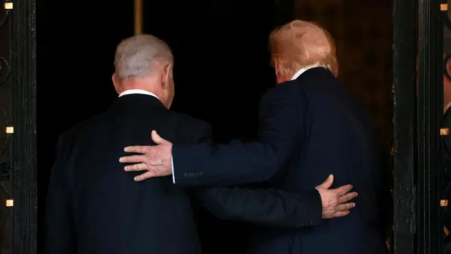 U.S. President Donald Trump and Israeli Prime Minister Benjamin Netanyahu embrace as they walk into Trump's Mar-a-Lago club