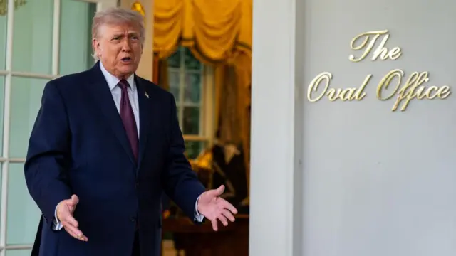 Trump gestures with both hands as he speaks outside the entrance to the Oval Office
