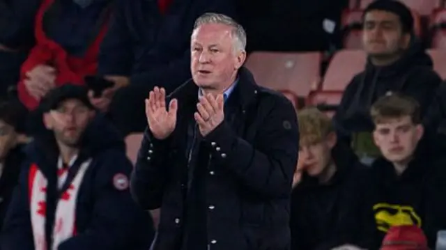 Michael O'Neill applauding from the Blackburn technical area