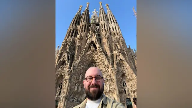 James Roach poses infront of La Sagrada Famila in Barcelona