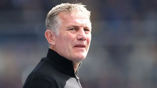 A concerned looking Phil Parkinson in a black zip jumper