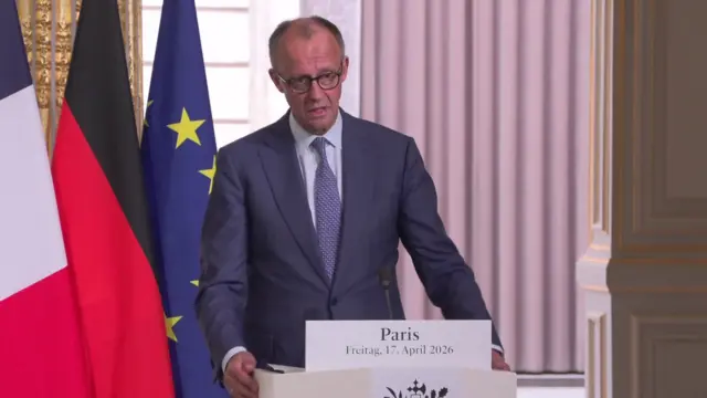 Merz speaking at news conference