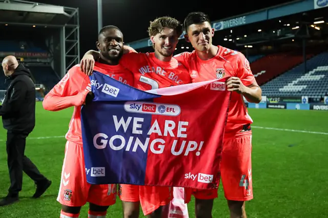 Frank Onyeka, Jack Rudoni, and Bobby Thomas of Coventry City celebrate promotion back to the Premier League