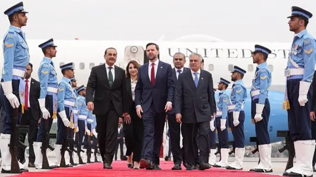 US Vice-President JD Vance walks off a plane flanked by senior Pakistani politicians. Photo date: 11 April 2026.