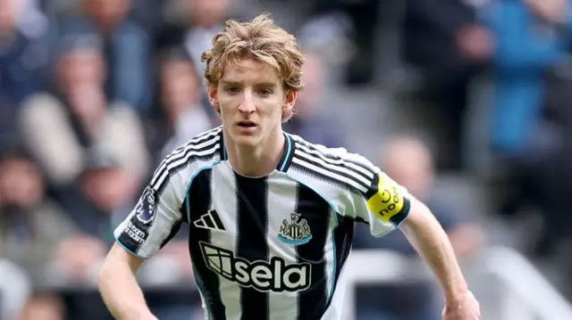 Newcastle's Anthony Gordon in black and white striped kit