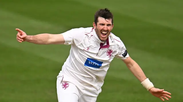 Craig Overton celebrates a wicket