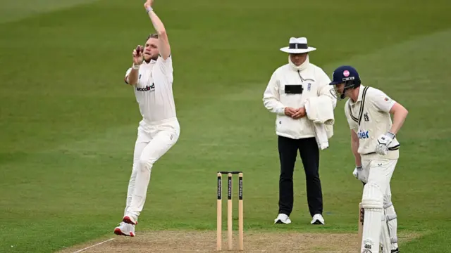 Sam Cook bowls against Warwickshire