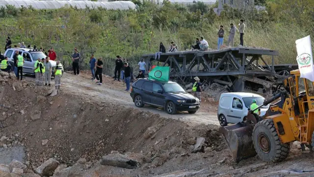 Vehicles cross as repairs continue to the bridge over the Litani river