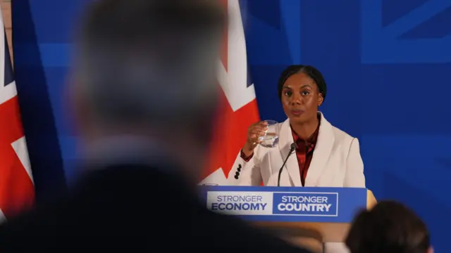 Kemi Badenoch at a podium